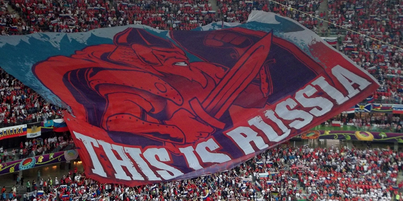 A large flag shown by the crowd at a football match which says This is Russia