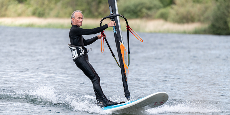 A man windsurfing on a lake