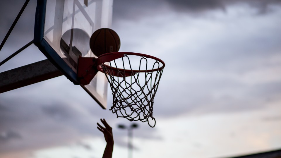 A basketball being thrown into a basketball hoop